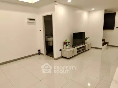 Spacious modern living room with sleek white tiles and minimalist decor