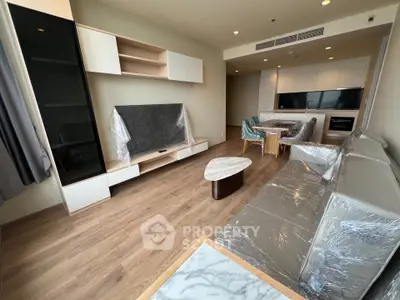 Modern living room with sleek furniture and open kitchen layout