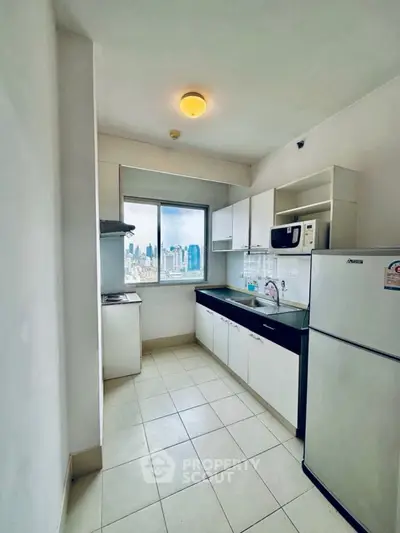 Modern kitchen with city view, featuring sleek appliances and ample storage space.