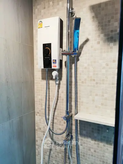 Modern bathroom with sleek shower and water heater in contemporary design.