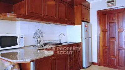 Charming kitchen with wooden cabinets and modern appliances, perfect for culinary enthusiasts.