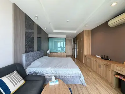 Modern studio apartment with stylish wood accents and cozy furnishings