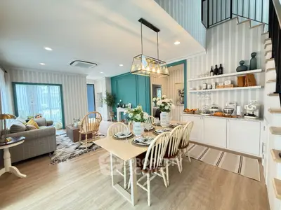 Spacious open-plan living and dining area with stylish decor and natural light.