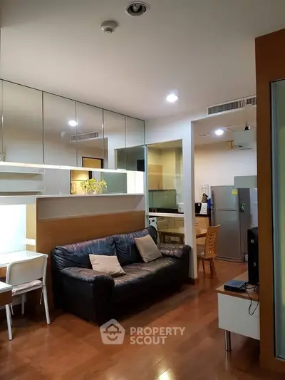 Modern living room with sleek kitchen and cozy seating area