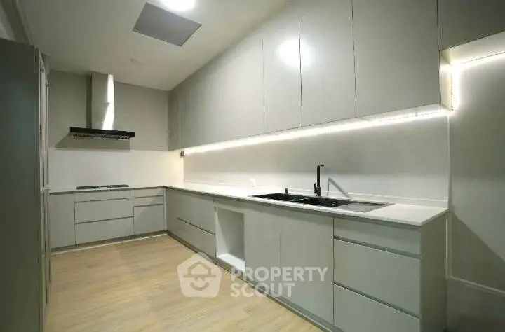 Modern kitchen with sleek cabinetry and integrated appliances in a minimalist design.