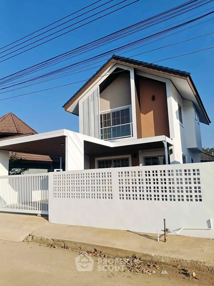Modern two-story house with unique architectural design and spacious outdoor area.