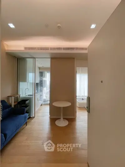 Modern apartment entrance with open layout and cozy seating area