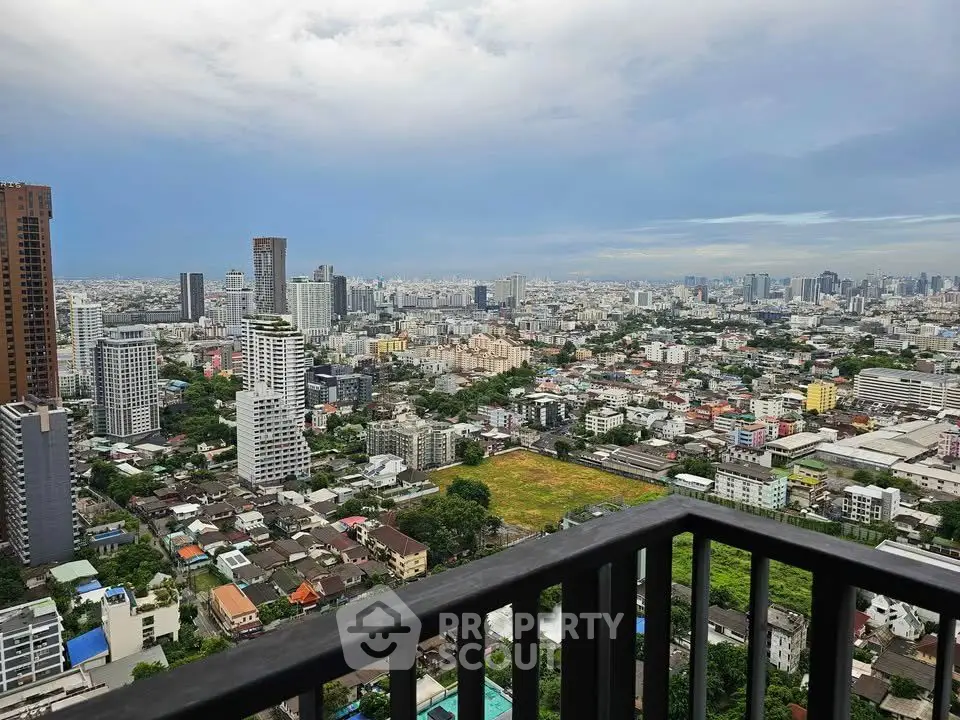 Stunning cityscape view from a high-rise balcony, showcasing urban skyline and vibrant city life.
