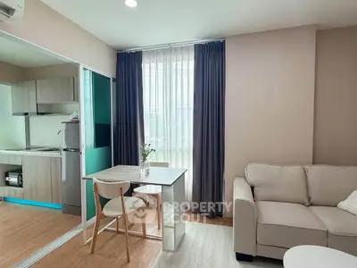 Modern living room with cozy sofa and dining area in open layout apartment