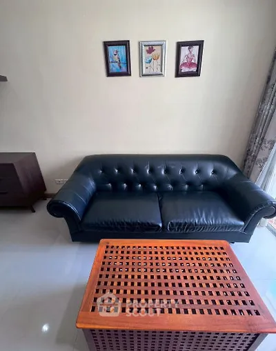 Stylish living room with elegant black leather sofa and wooden coffee table, perfect for modern interiors.