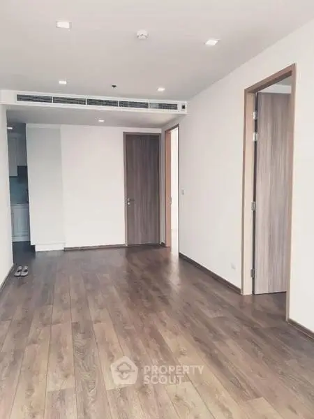 Spacious empty living room with wooden flooring and modern design