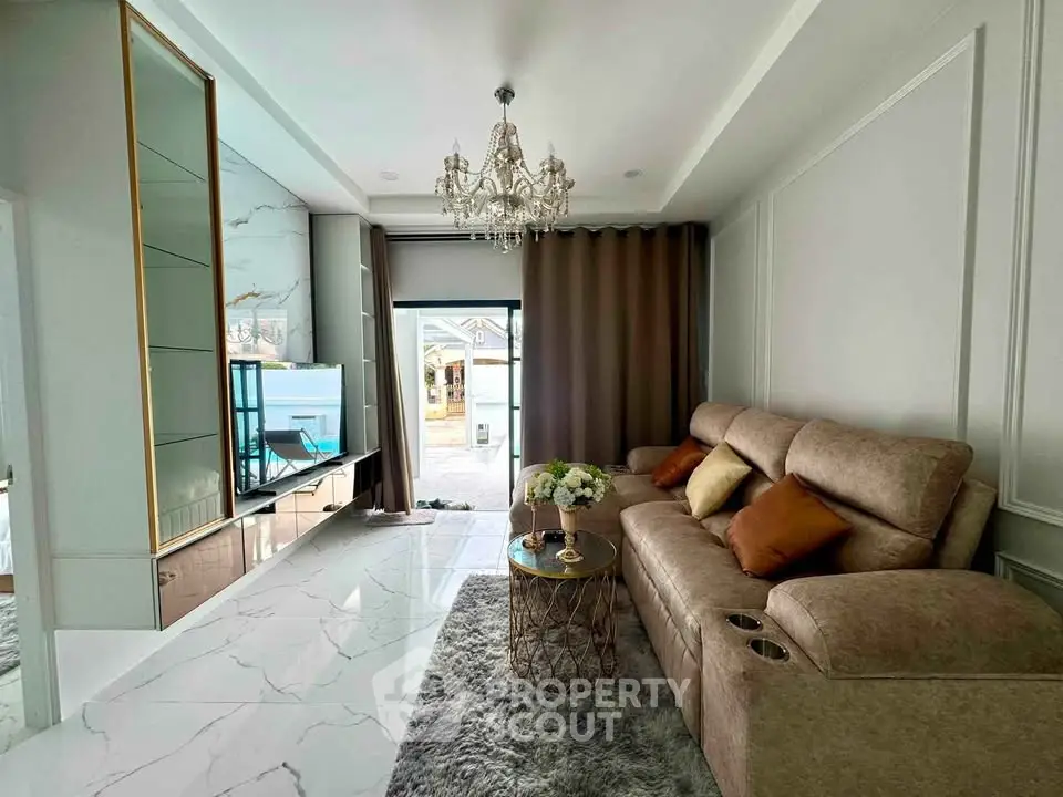 Luxurious living room with elegant chandelier and plush seating in modern home