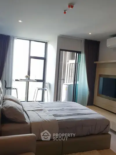 Modern bedroom with balcony and natural light in stylish apartment