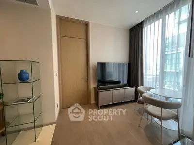 Modern living room with sleek TV setup and elegant glass shelving