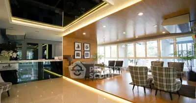 Luxurious modern living room with elegant decor and large windows offering natural light.