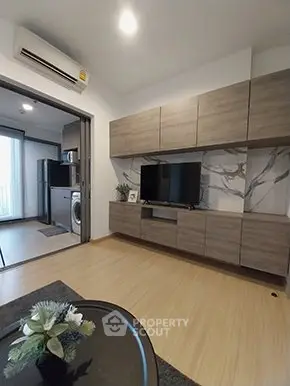 Modern living room with stylish cabinetry and open kitchen layout