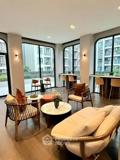 Stylish modern living room with large windows and elegant furniture in a contemporary apartment.