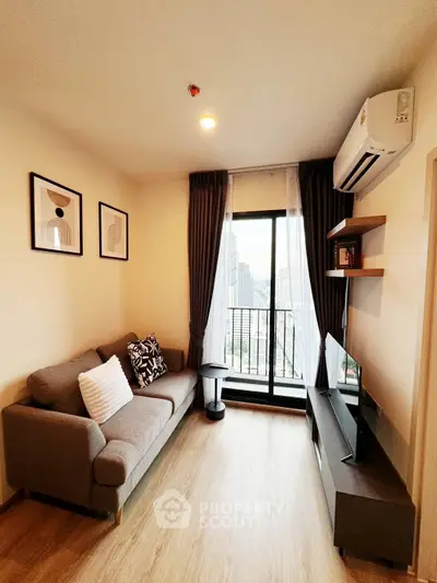 Modern living room with city view, stylish decor, and natural light.