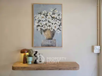 Stylish interior wall with elegant floral painting and modern decor accents.
