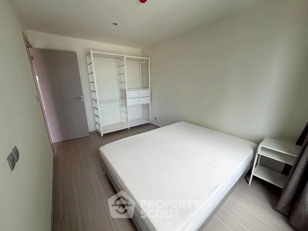 Spacious bedroom with minimalist design and ample natural light