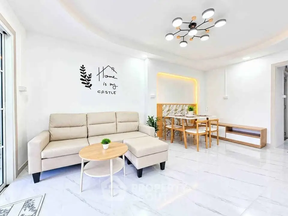 Modern living room with stylish furniture and elegant lighting in a bright, open space.