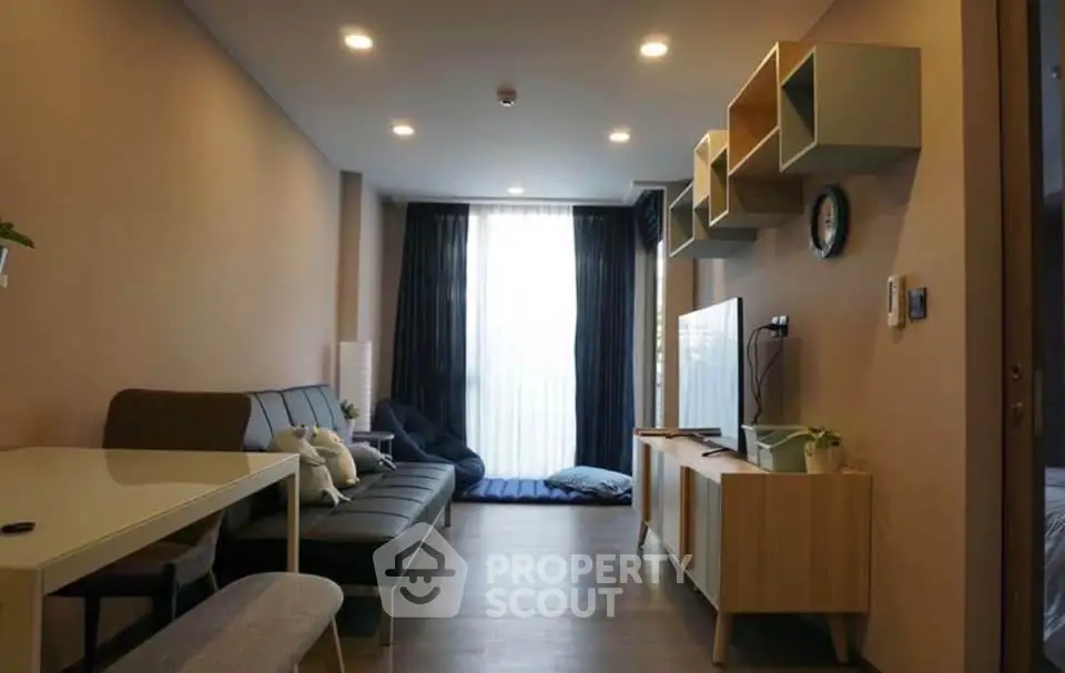 Modern living room with stylish furniture and natural light, perfect for relaxation and entertainment.
