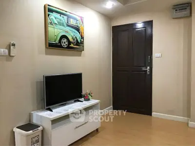 Cozy living room with modern TV setup and stylish decor in a contemporary apartment.