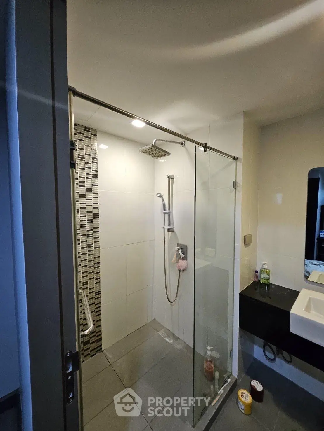 Modern bathroom with glass shower enclosure and sleek fixtures