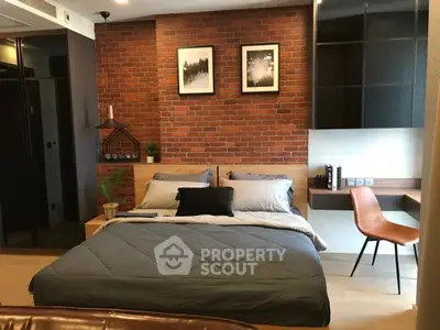 Modern bedroom with exposed brick wall and stylish decor