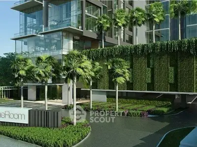 Luxurious modern building exterior with lush greenery and palm trees, showcasing elegant architectural design.