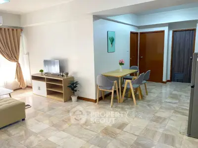Spacious open-plan living and dining area with modern decor and natural light.