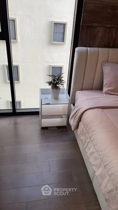 Modern bedroom with large window and stylish decor