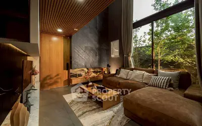 Luxurious living room with floor-to-ceiling windows and elegant decor