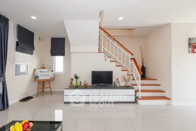 Modern living room with sleek staircase and stylish decor