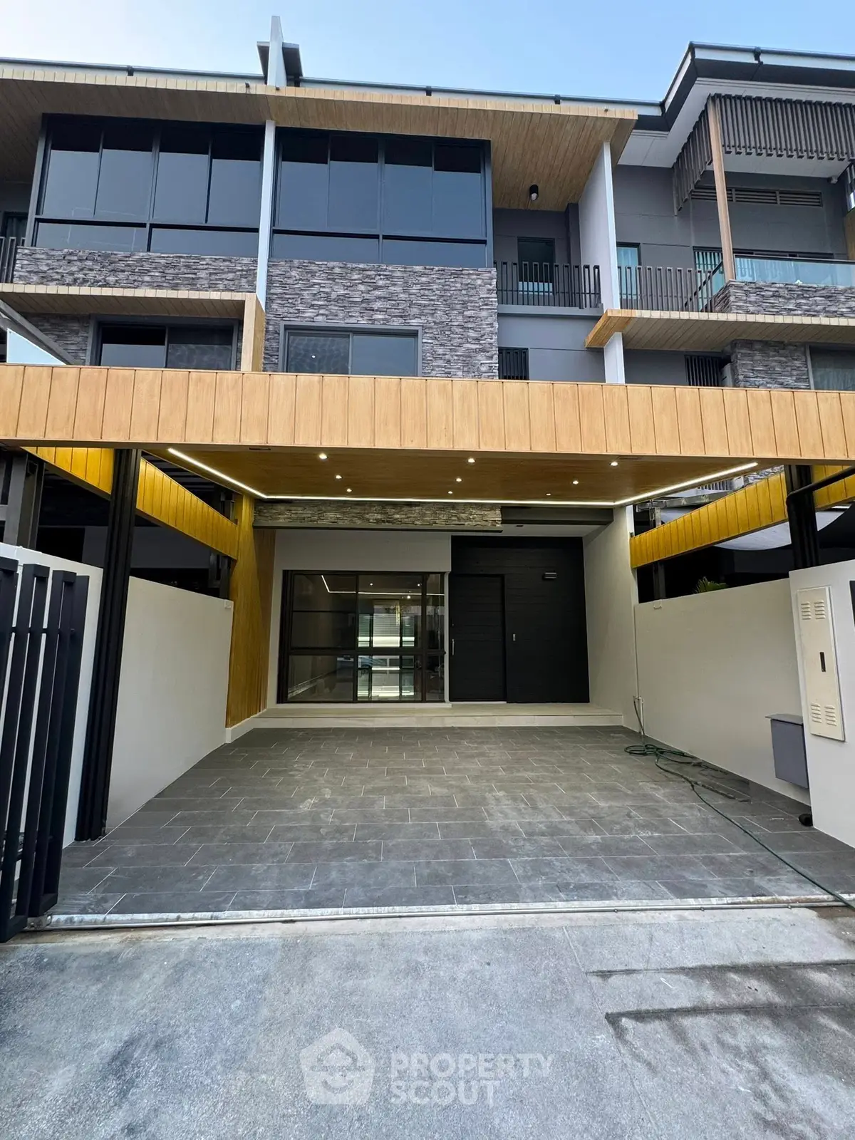 Modern townhouse exterior with sleek design and spacious garage