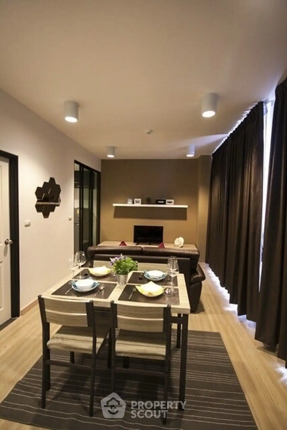 Modern living room with dining area, stylish decor, and cozy ambiance.