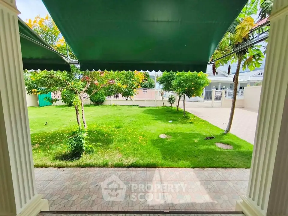 Charming garden view from a covered patio in a serene residential area.