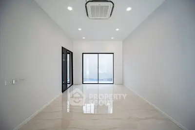 Spacious modern living room with sleek design and large windows