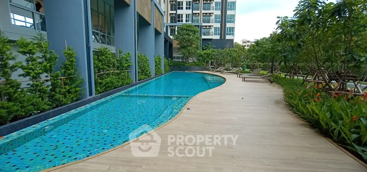 Luxurious condo poolside with lush greenery and modern architecture