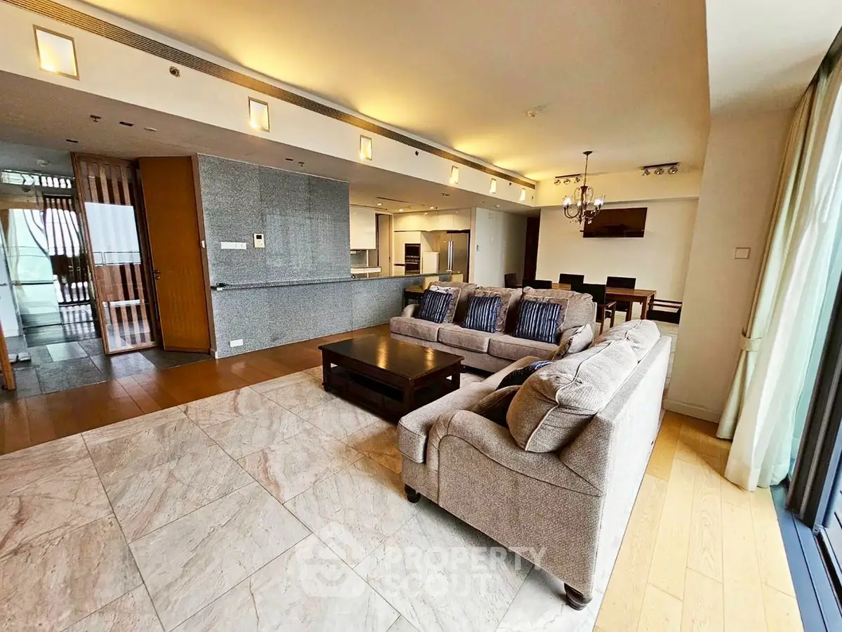 Spacious open-plan living room with modern kitchen and elegant dining area.