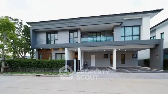 Modern two-story house with sleek design and spacious driveway