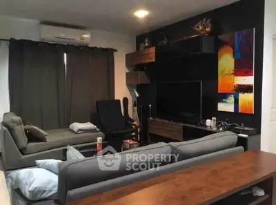 Stylish living room with modern furniture and wall art, perfect for relaxation.
