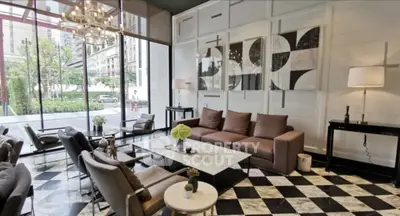Luxurious modern living room with marble floors and large windows in upscale property.