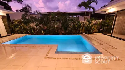 Luxurious modern pool area with elegant tile design and lush greenery