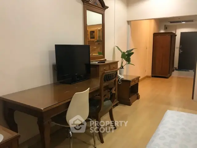 Spacious living area with elegant wooden furniture and modern decor