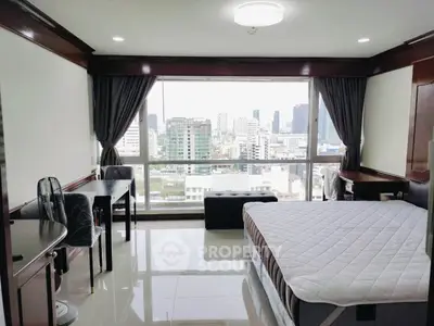 Spacious bedroom with city view and modern furnishings