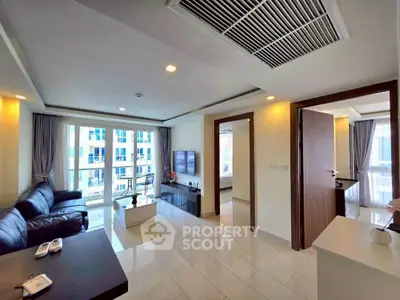 Spacious modern living room with sleek design and abundant natural light in a luxury apartment.