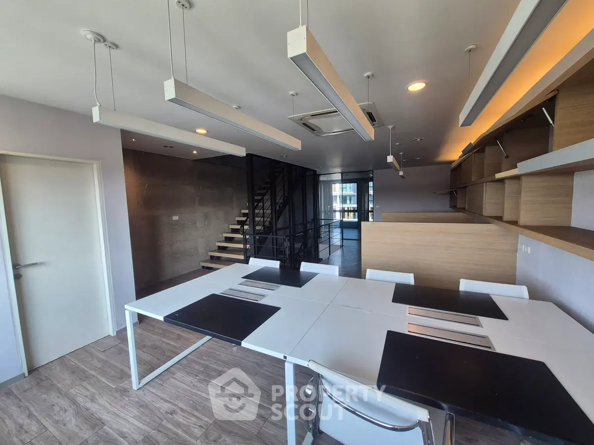 Modern open-plan living space with sleek design and ample natural light.