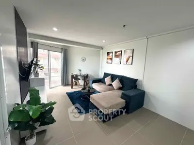 Modern living room with stylish decor and cozy seating area, perfect for relaxation and entertainment.