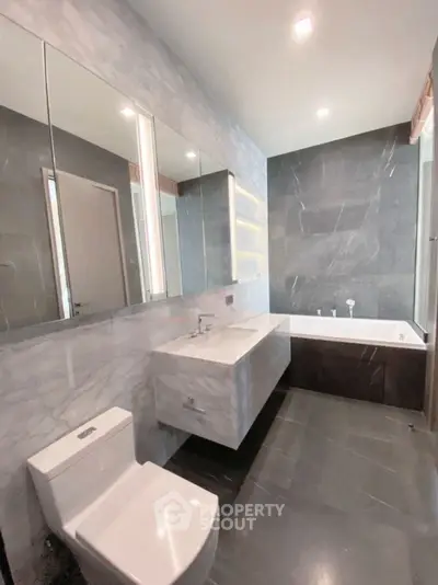 Luxurious modern bathroom with sleek marble finishes and elegant fixtures.